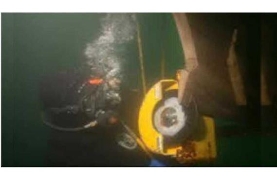 Diver operating hydraulic cutting equipment underwater